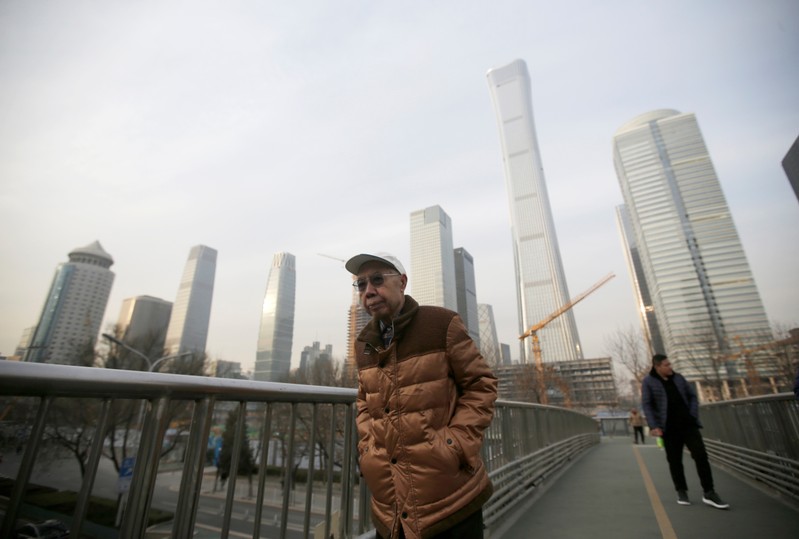 People walk through an overpass near Beijing's central business area