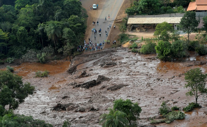 FILE PHOTO: Residents are seen in an area next to a dam owned by Brazilian miner Vale SA that burst