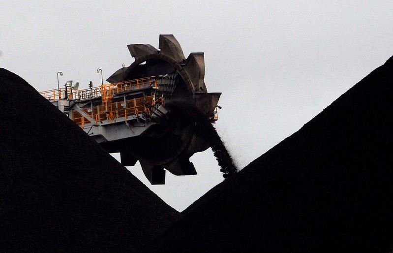 FILE PHOTO: A reclaimer places coal in stockpiles at the coal port in Newcastle