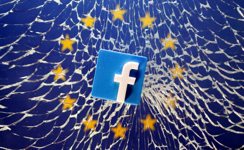 FILE PHOTO: A 3D printed Facebook logo is placed on broken glass above a printed EU flag in this illustration