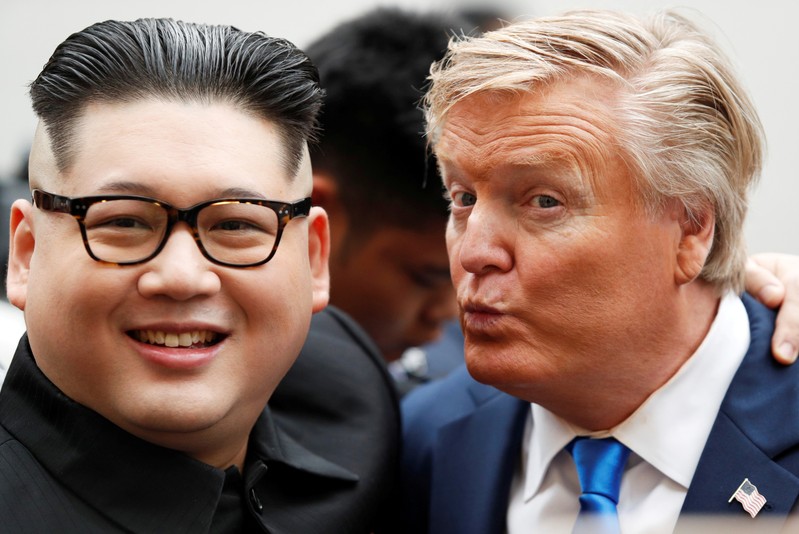 Howard X, an Australian-Chinese impersonator of North Korean leader Kim Jong Un and Russell White, who is impersonating U.S. President Donald Trump, pose for a photo outside the Opera House, ahead of the upcoming Trump-Kim summit in Hanoi