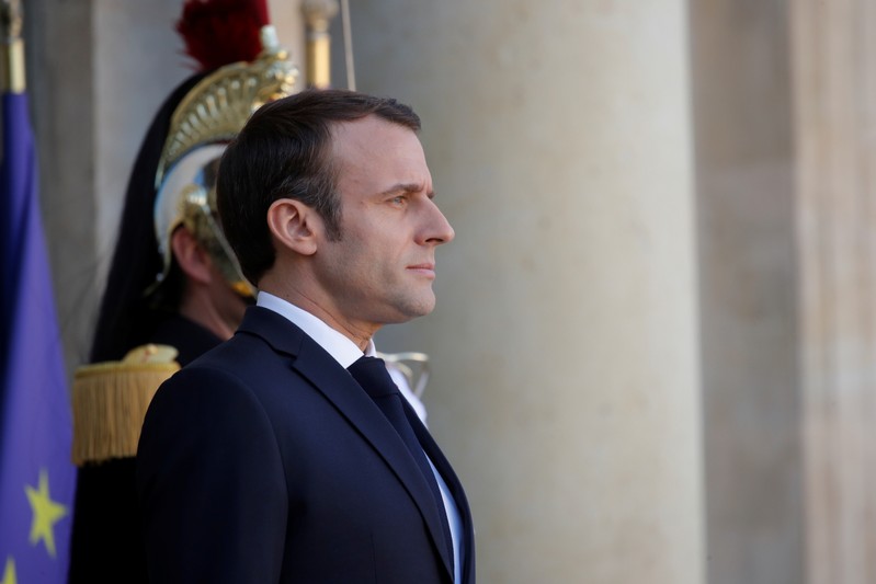 French President Emmanuel Macron waits for the arrival of a guest at the Elysee Palace in Paris