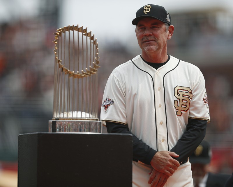 San Francisco Giants Manager Bochy stands next to the World Series trophy before their MLB National League baseball game against St. Louis Cardinals in San Francisco