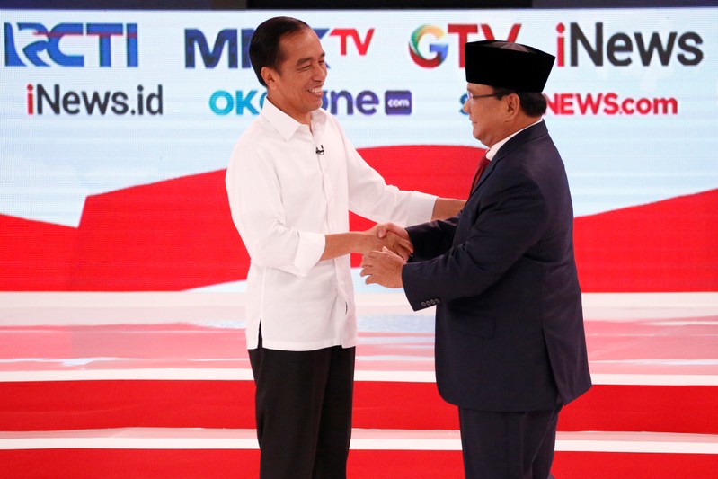 Indonesia's presidential candidate Joko Widodo shakes hands with his opponent Prabowo Subianto after the second debate between presidential candidates ahead of the next general election in Jakarta