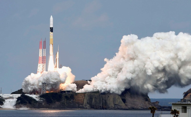 FILE PHOTO: A H-IIA rocket carrying Hayabusa 2 space probe blasts off from the launching pad at Tanegashima Space Center on the Japanese southwestern island of Tanegashima