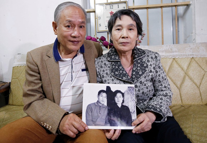 Former Vietnamese chemical student Pham Ngoc Canh who studied in North Korea and his North Korean wife Ri Yong Hui hold their first photo together which was taken in Spring 1971, at their house in Hanoi