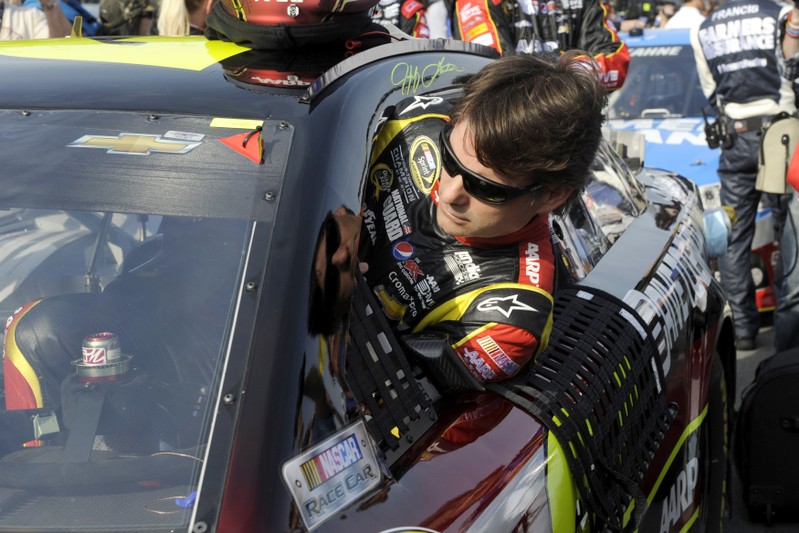 Jeff Gordon climbs into his number 24 Chevrolet for the start of the second NASCAR Sprint Cup Series Budweiser Duel at the Daytona International Speedway in Daytona Beach