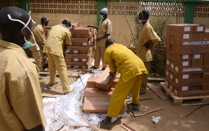 Workers arrange voting materials for distribution at INEC headquarters in Kano