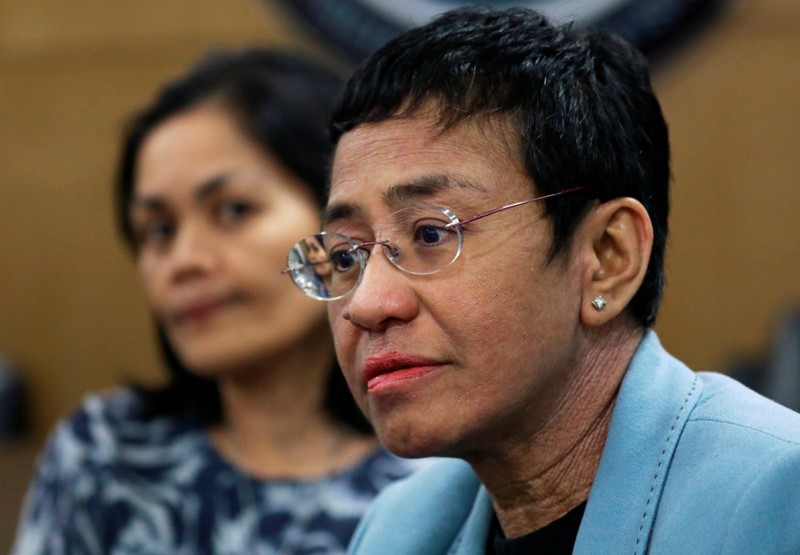 Rappler's CEO Maria Ressa waits inside the National Bureau of Investigation in Manila