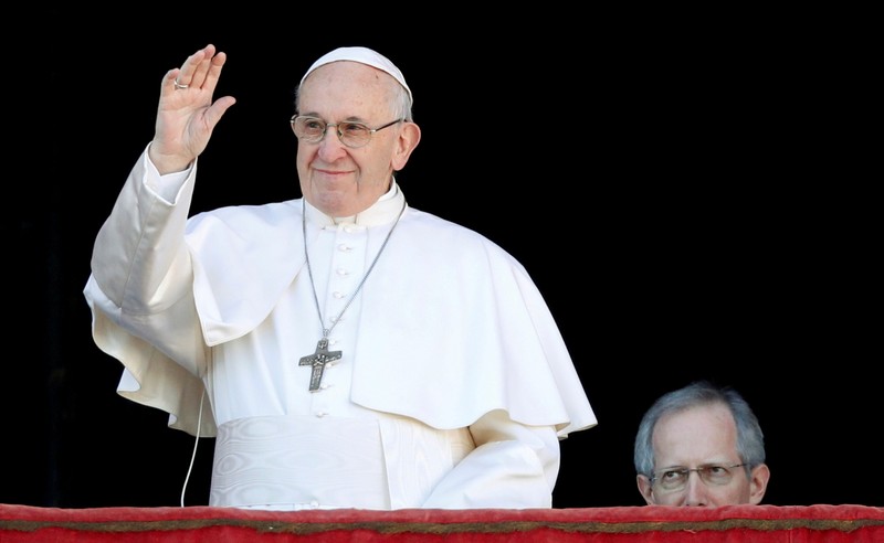 FILE PHOTO: Pope Francis waves as he arrives to deliver the 