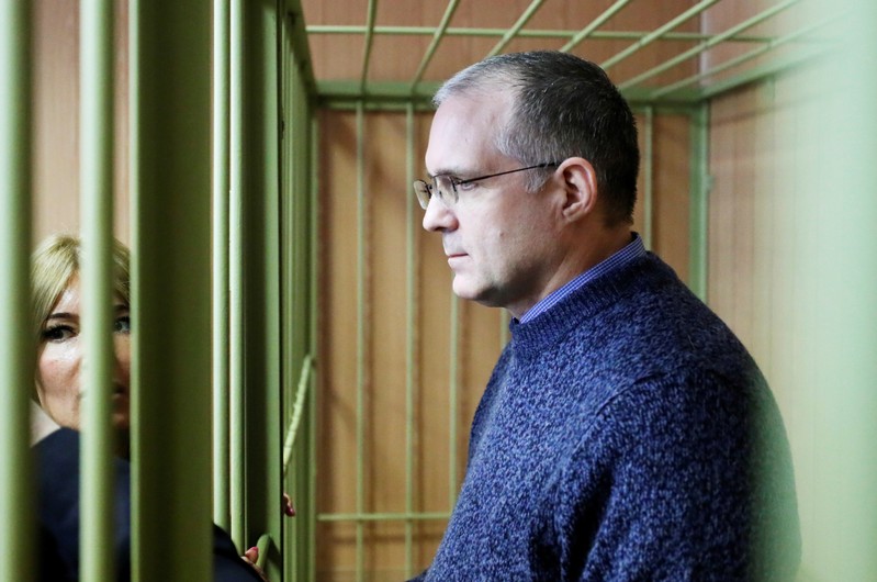 Former U.S. marine Paul Whelan who is being held on suspicion of spying, stands in the courtroom cage after a ruling regarding extension of his detention, in Moscow