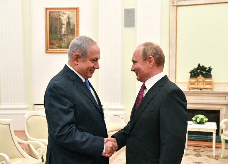 FILE PHOTO: Russian President Putin shakes hands with Israeli PM Netanyahu during their meeting at the Kremlin in Moscow
