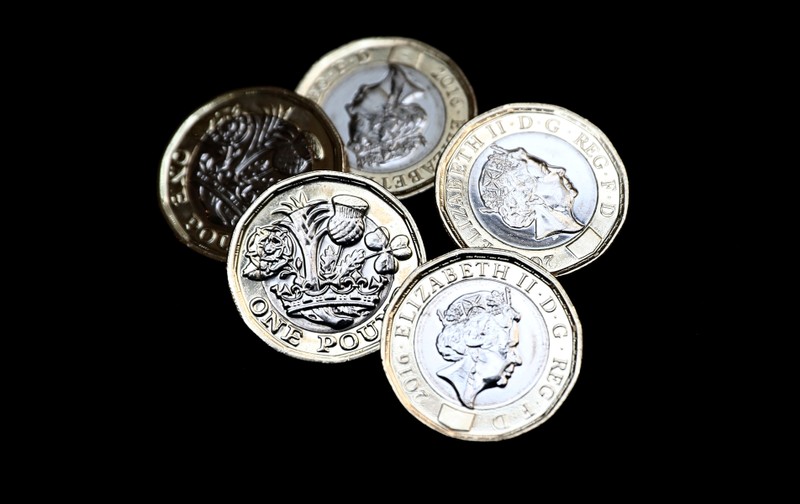 New one pound coins, which come into circulation today, are seen in London