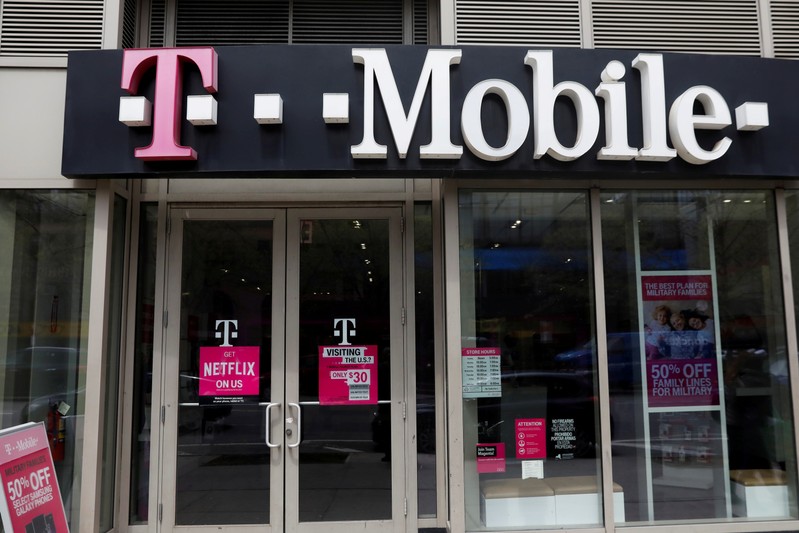 FILE PHOTO: A sign for a T-Mobile store is seen in Manhattan, New York