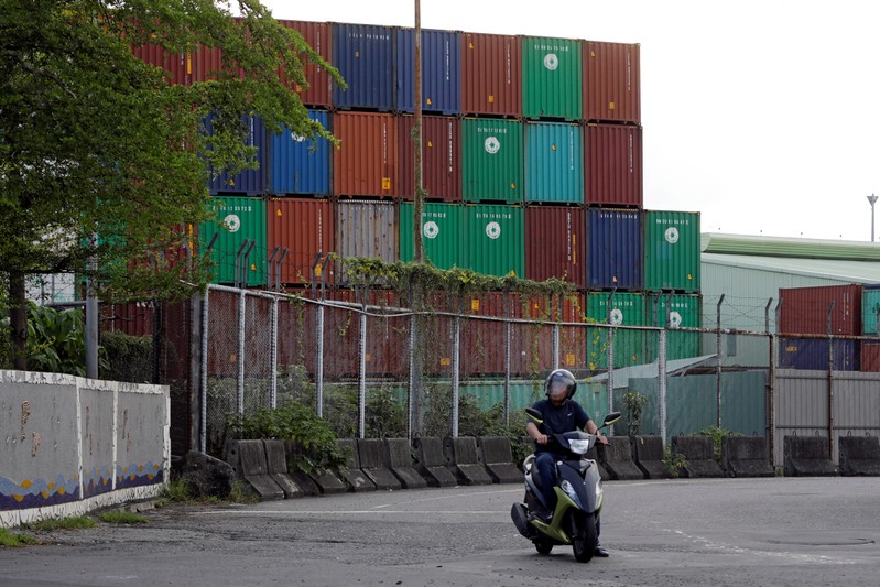 FILE PHOTO: A man rides a motorbike near Kaohsiung Port