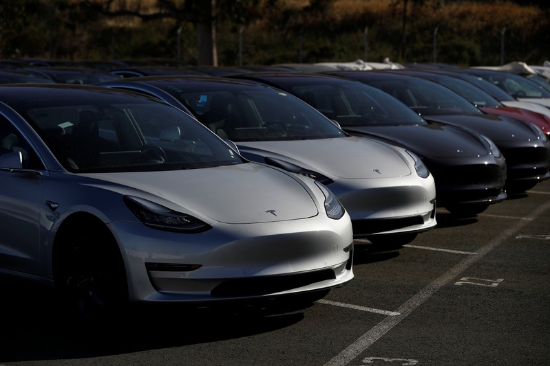 A row of new Tesla Model 3 electric vehicles is seen at a parking lot in Richmond, California
