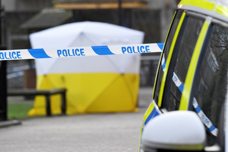 FILE PHOTO: A police car is parked next to crime scene tape, as a tent covers a park bench on which former Russian inteligence officer Sergei Skripal, and a woman were found unconscious after they had been exposed to an unknown substance, in Salisbury