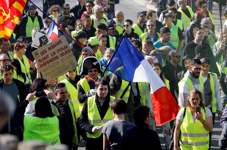 Protesters wearing yellow vests take part in a demonstration of the 