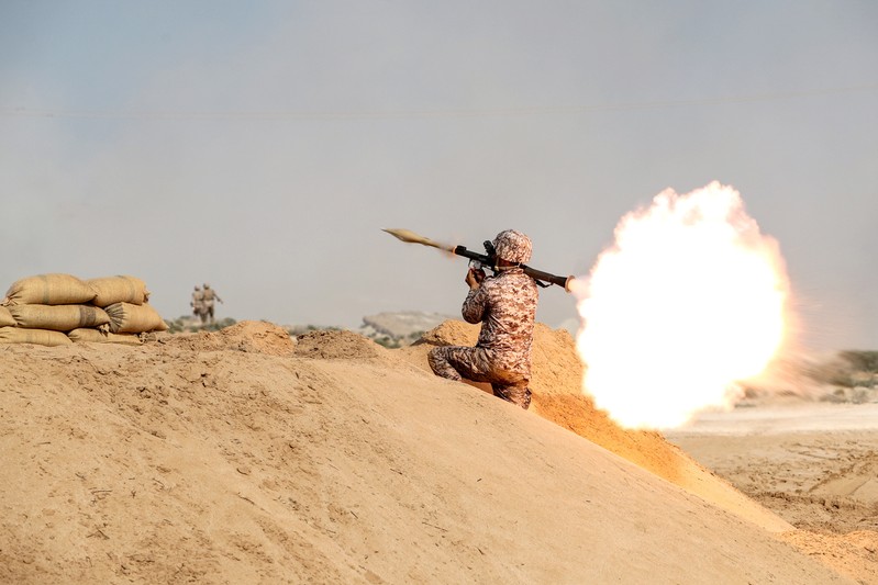 FILE PHOTO: A member of military units of the IRGC Ground Force fires a rocket launcher as they launched war games in the Gulf