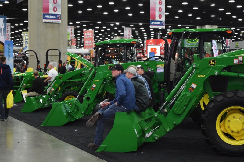 People look at Deere equipment as they attend National Farm Machinery show in Louisville