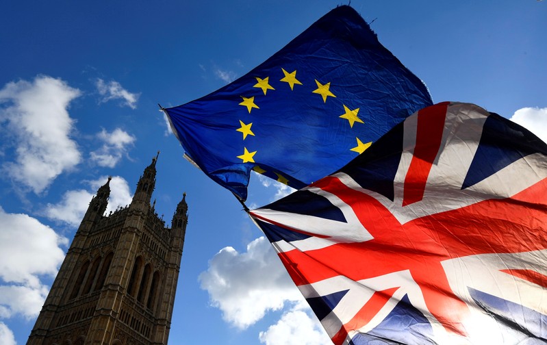 FILE PHOTO: British and EU flags flutter outside the Houses of Parliament in London