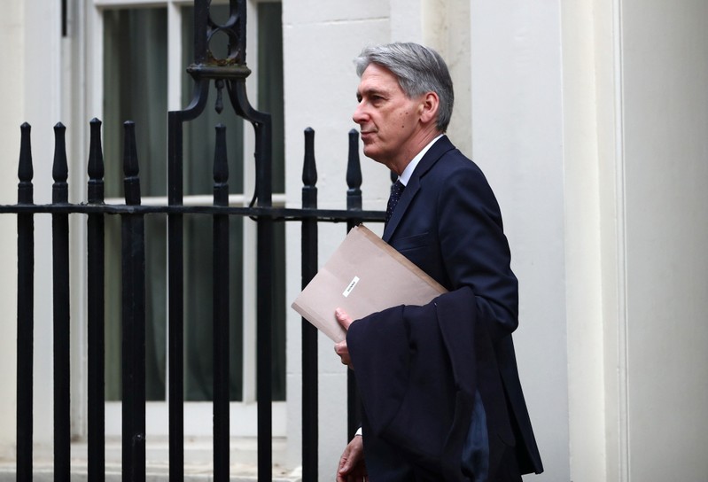 Britain's Chancellor of the Exchequer Philip Hammond is seen outside Downing Street in London