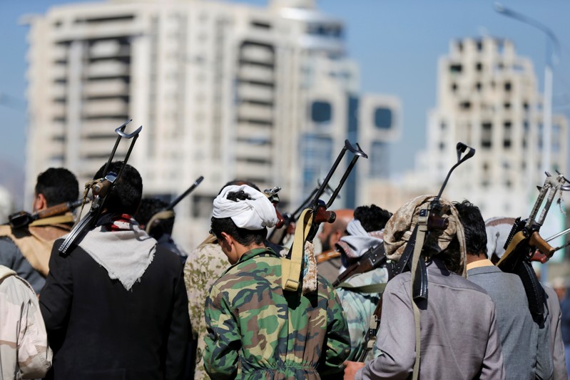 FILE PHOTO - Armed Houthi followers carry their rifles as they attend a gathering to show support for Houthi movement in Sanaa