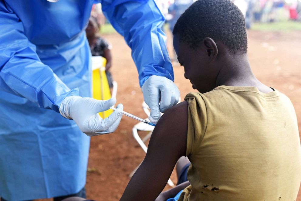 A Congolese health worker administers Ebola vaccine to a boy who had contact with an Ebola sufferer in the village of Mangina in North Kivu province of the Democratic Republic of Congo, Aug.18, 2018.