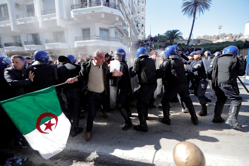Police officers try to disperse people trying to reach the government palace during a protest against President Abdelaziz Bouteflika's plan to extend his 20-year rule by seeking a fifth term in April elections in Algiers