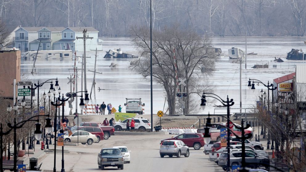 People view the rising waters from the Platte and Missouri rivers which flooded areas of Plattsmouth, Neb., Sunday, March 17, 2019. Hundreds of people remained out of their homes in Nebraska, but rivers there were starting to recede.