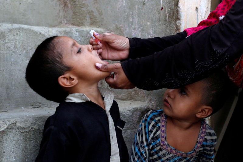 Boy receives polio vaccine drops during an anti-polio campaign in Karachi