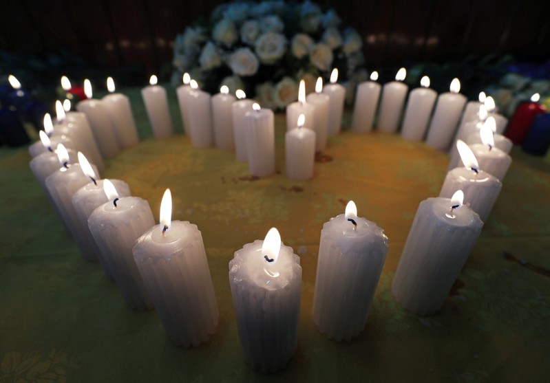 Candles arranged in a heart-shape at a prayer session, as relatives mourn their kin, during a commemoration ceremony for the victims at the scene of the Ethiopian Airlines Flight ET 302 plane crash, at the Kenyan Embassy in Addis Ababa