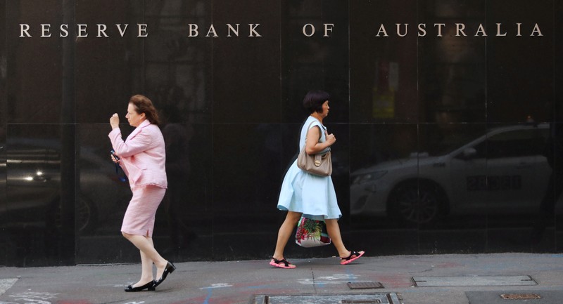 FILE PHOTO: Two women walk next to the Reserve Bank of Australia headquarters in central Sydney