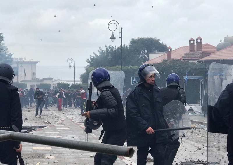 Anti riot police clash with people protesting against President Abdelaziz Bouteflika, in Algiers