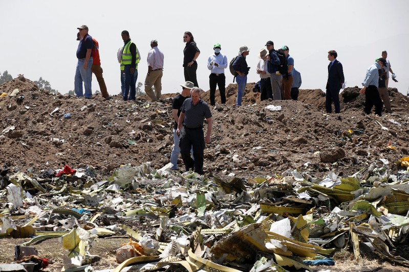 American civil aviation and Boeing investigators search through the debris at the scene of the Ethiopian Airlines Flight ET 302 plane crash, near the town of Bishoftu