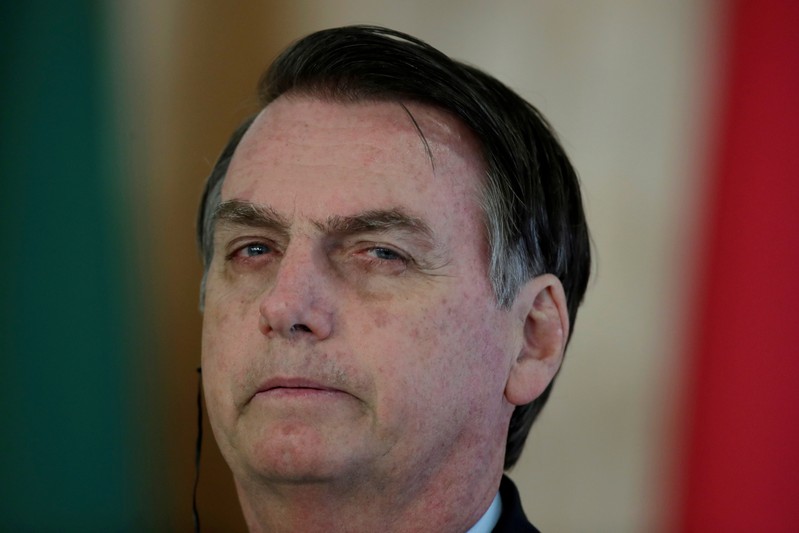 FILE PHOTO: Brazil's President Jair Bolsonaro listens to Paraguay's President Mario Abdo during a meeting at the Planalto Palace in Brasilia