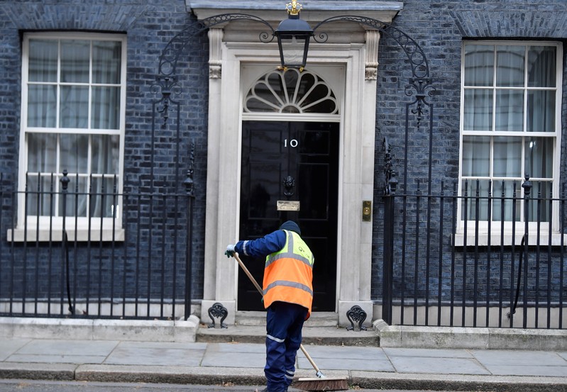 Man sweeps outside 10 Downing Street in London