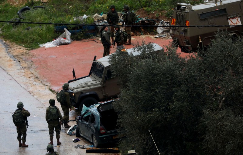Israeli forces gather at the scene of an incident near Ramallah, in the Israeli-occupied West Bank