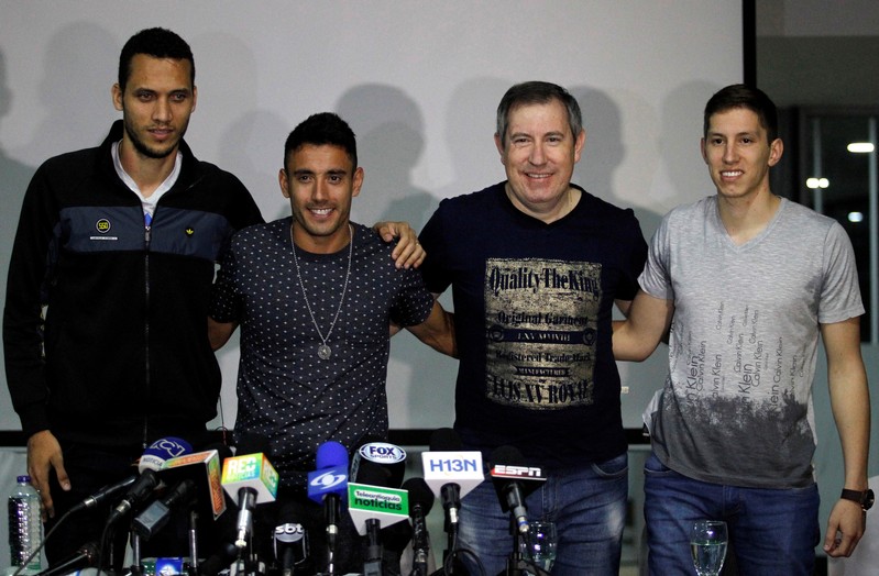 Soccer players of Brazil's Chapecoense Neto, Ruschel and Follman and survivor journalist Henzel, survivors of the team's plane crash, pose during a news conference upon their arrival in Medellin, Colombia