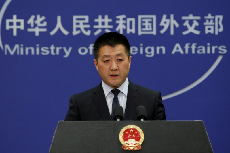 Chinese Foreign Ministry spokesman Lu Kang answers questions about a major bus accident in North Korea, during a news conference in Beijing