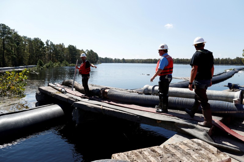 FILE PHOTO: Santee Cooper workers check the water levels around a 6000 foot long Aqua Dam built to keep sediment from a coal ash retention pond from going into the flooded Waccamaw River in the aftermath of Hurricane Florence in Conway
