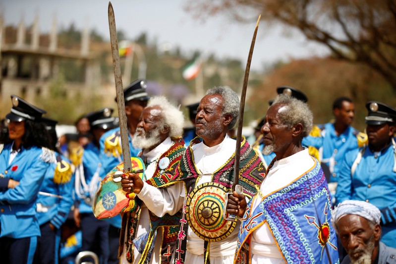Ethiopian military veterans hold their war machetes as they gesture during the 121st celebration of the battle of Adwa between the Ethiopian Empire and the Kingdom of Italy near the town of Adwa, Ethiopia's Tigray region