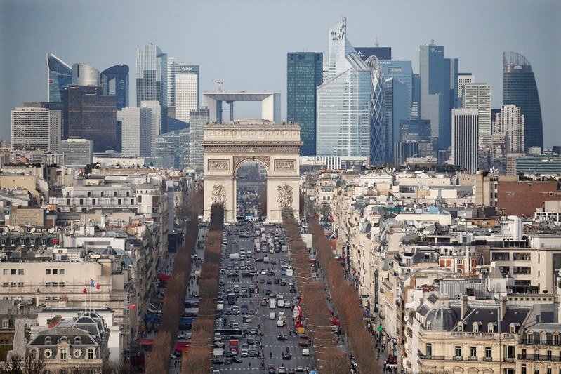 General view of the skyline of La Defense business district with its Arche behind Paris' landmark, the Arc de Triomphe and the Champs Elysees avenue in Paris
