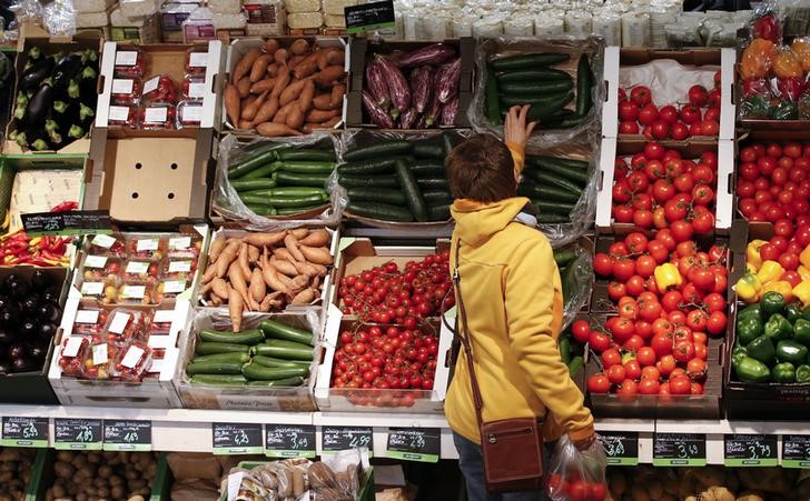 A woman checks vegetables at the Biocompany organic supermarket in Berlin