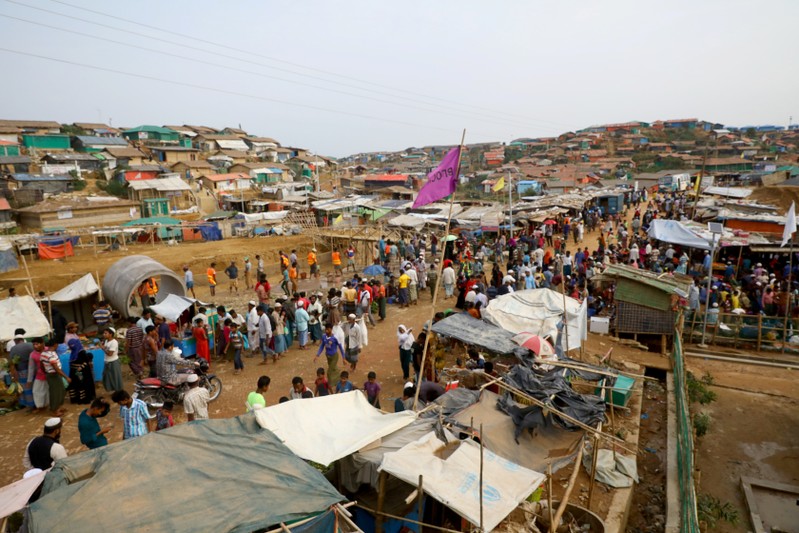 FILE PHOTO: Rohingya refugees gather at a market inside a refugee camp in Cox's Bazar