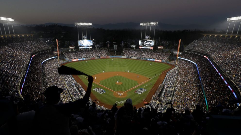 Fans cheer from the top of Dodger Stadium during Game 4 of the World Series baseball game between the Boston Red Sox and Los Angeles Dodgers on Saturday, Oct. 27, 2018, in Los Angeles.