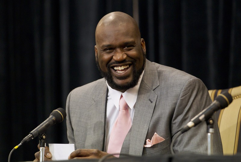 Shaquille O'Neal laughs as he announces his retirement from NBA at a news conference in Windermere