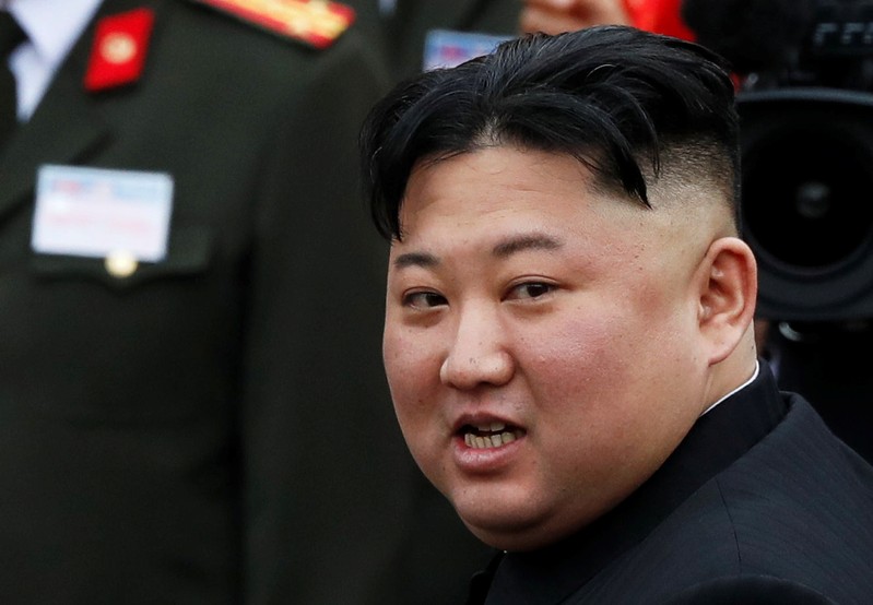 North Korean leader Kim Jong Un makes his way to board a train to depart for North Korea at Dong Dang railway station