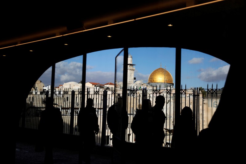People look out from a building facing the Dome of the Rock, located in Jerusalem's Old City on the compound known to Muslims as Noble Sanctuary and to Jews as Temple Mount