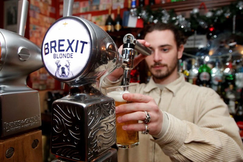 FILE PHOTO: Thibault, barman at the Cricketer English Pub, serves a Brexit draft beer in Paris